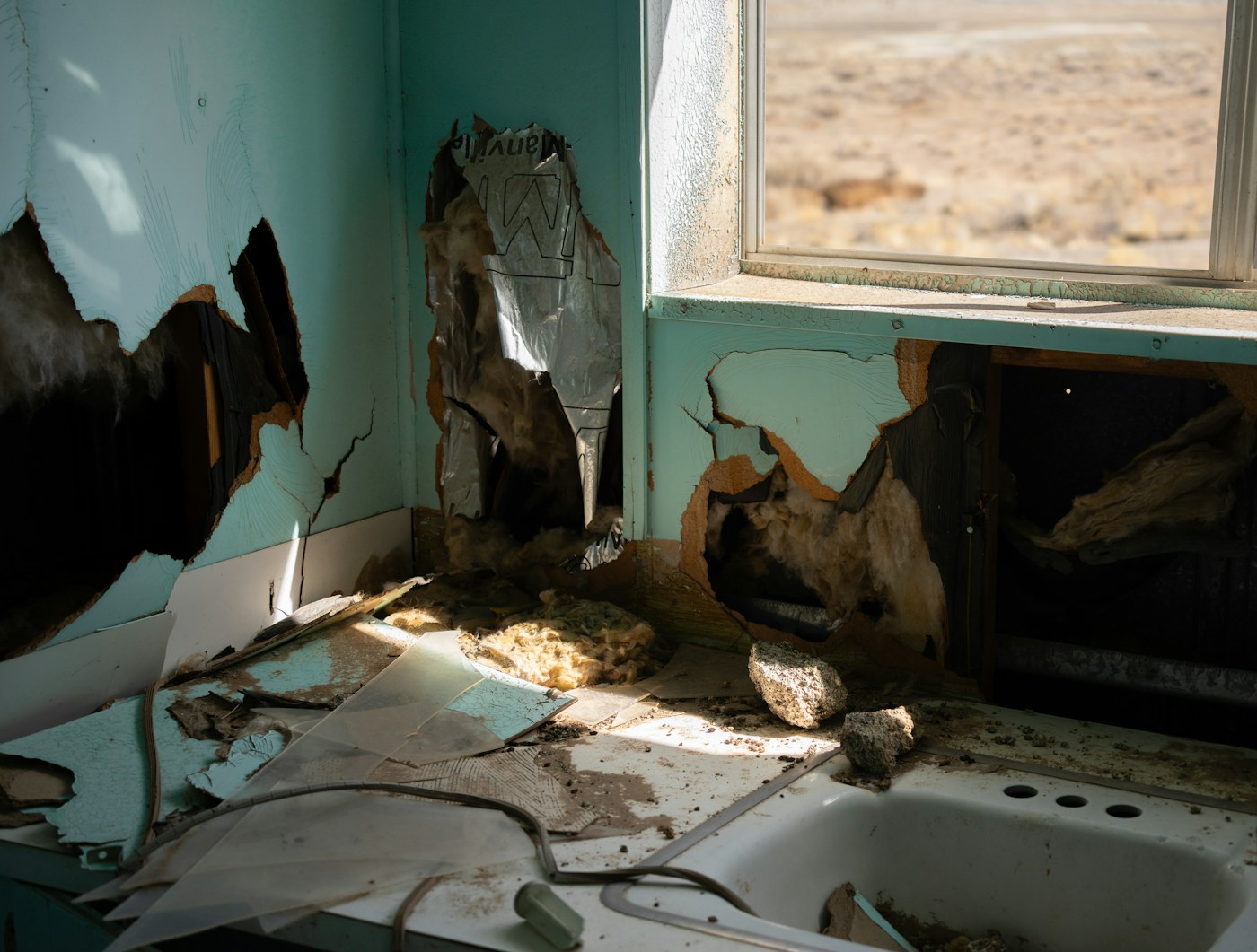 Severe moisture-damaged interior wall and kitchen materials